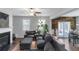 Open living room with fireplace and view of the dining room and lots of natural light at 1077 Roanoke Ave, Mcdonough, GA 30253