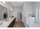 Spacious bathroom featuring a large vanity, and soaking tub with bright natural light at 1077 Roanoke Ave, Mcdonough, GA 30253