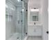 Bathroom with walk-in shower and vanity featuring a neutral color palette and modern lighting at 1090 Larosa Dr, Lawrenceville, GA 30043