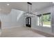 Elegant foyer with light wood floors, decorative molding, and modern lighting at 1090 Larosa Dr, Lawrenceville, GA 30043