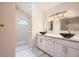 Bathroom featuring double sinks, marble countertops, white cabinets and modern lighting at 2068 Bedford Ct, Lithonia, GA 30058