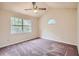 Bright bedroom featuring vaulted ceiling, ceiling fan, and large picture window with backyard views at 2068 Bedford Ct, Lithonia, GA 30058