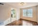 Cozy dining area with wood floors, a modern chandelier, and a view into the kitchen at 2068 Bedford Ct, Lithonia, GA 30058