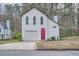 Charming two-story home with white siding, attached garage, and a beautifully colored front door at 2068 Bedford Ct, Lithonia, GA 30058