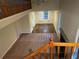 View of a hallway from the stairway showcasing carpeted floors and views of the living areas at 2068 Bedford Ct, Lithonia, GA 30058