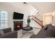 Inviting living room with a fireplace, large windows, and a staircase leading to the upper level at 2068 Bedford Ct, Lithonia, GA 30058
