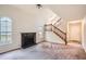 Inviting living room with a fireplace, large windows, and a staircase leading to the upper level at 2068 Bedford Ct, Lithonia, GA 30058