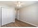 Bedroom with closet, ceiling fan, vinyl floors, and neutral paint at 2454 Brianna Dr, Hampton, GA 30228