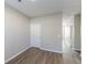 Neutral bedroom features wood-look flooring, natural light, and a crisp, neutral color palette at 2454 Brianna Dr, Hampton, GA 30228