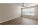 Serene bedroom with wood-look floors, neutral walls, ceiling fan and large window for ample natural light at 2454 Brianna Dr, Hampton, GA 30228