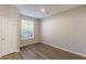 Neutral bedroom features wood-look flooring, natural light, and a crisp, neutral color palette at 2454 Brianna Dr, Hampton, GA 30228