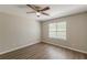 Bedroom featuring ample natural light from a window with a ceiling fan and hardwood floors at 2454 Brianna Dr, Hampton, GA 30228