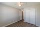 Bedroom features closet and entrance to the bathroom with hardwood floors and a ceiling fan at 2454 Brianna Dr, Hampton, GA 30228