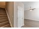 Welcoming entryway featuring stairs, neutral walls, and wood-look flooring, illuminated by a ceiling fan at 2454 Brianna Dr, Hampton, GA 30228