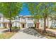 Charming two-story townhome with a well-maintained driveway and landscaping, set against a bright blue sky at 2454 Brianna Dr, Hampton, GA 30228