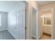 Hallway view showcasing the doors to the bedrooms and bathroom area with modern fixtures and finishes at 2454 Brianna Dr, Hampton, GA 30228