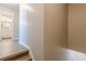 Hallway with stairs and views of a bathroom, enhanced by wood flooring, creates inviting ambiance at 2454 Brianna Dr, Hampton, GA 30228