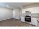 Open kitchen boasts granite counters, stainless appliances, and white cabinets, a seamless blend of style and functionality at 2454 Brianna Dr, Hampton, GA 30228