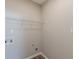 A clean and utilitarian laundry room offers practical storage with a wire rack shelf at 2454 Brianna Dr, Hampton, GA 30228