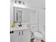 Bright bathroom featuring a vanity with white cabinets, black hardware, and a large mirror at 3060 Eastland Way, Snellville, GA 30078