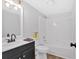 Well-lit bathroom featuring a modern vanity, mirror and shower-tub combination at 3060 Eastland Way, Snellville, GA 30078