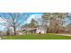 Well-maintained split-level home featuring an attached two-car garage and a lush green lawn at 3060 Eastland Way, Snellville, GA 30078