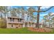 Charming split-level home with stone accents, well-manicured lawn, and mature trees for curb appeal at 3060 Eastland Way, Snellville, GA 30078