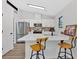 Bright kitchen features a breakfast bar, stainless steel appliances, and white cabinetry at 3060 Eastland Way, Snellville, GA 30078