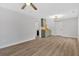 Open-concept living room with modern decor, wood-look flooring and kitchen with olive green cabinets at 3060 Eastland Way, Snellville, GA 30078