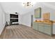 Open-concept living room with a fireplace, stylish furniture, next to the kitchen with olive green cabinets at 3060 Eastland Way, Snellville, GA 30078