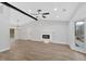 Spacious living area featuring wood-look floors, a modern fireplace, and modern lighting at 3060 Eastland Way, Snellville, GA 30078
