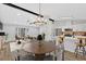 Open-concept living and dining area featuring modern finishes, a stylish chandelier, and island seating at 3060 Eastland Way, Snellville, GA 30078