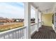 Inviting balcony with classic white pillars and wood flooring, perfect for relaxing outdoors at 403 Inglenook Walk, Marietta, GA 30060