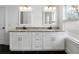Modern bathroom featuring dual sinks, white cabinetry, granite countertops, and black marble-look floor tiles at 403 Inglenook Walk, Marietta, GA 30060