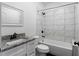Modern bathroom featuring marble-style tiling, a granite countertop, and a sleek, white vanity at 403 Inglenook Walk, Marietta, GA 30060