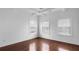 Bright bedroom with hardwood floors, multiple windows, and a decorative trey ceiling feature at 403 Inglenook Walk, Marietta, GA 30060