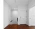 Hallway with hardwood floors, white walls, and doorways to the lift and stairs at 403 Inglenook Walk, Marietta, GA 30060
