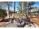 Stone fire pit surrounded by chairs in a backyard setting, perfect for outdoor entertaining and gatherings at 5569 Snowy Orchid Dr, Sugar Hill, GA 30518