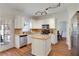 Well-lit kitchen with hardwood floors, white cabinets, stainless steel appliances, and stone countertops at 5569 Snowy Orchid Dr, Sugar Hill, GA 30518