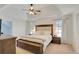 Serene bedroom features a tray ceiling and natural light at 5569 Snowy Orchid Dr, Sugar Hill, GA 30518