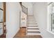 Bright entryway featuring hardwood floors and a staircase with white risers at 6838 Prelude Dr, Atlanta, GA 30328