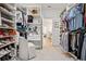 Well-organized walk-in closet with extensive shelving, hanging rods, and a vanity area with seating at 6838 Prelude Dr, Atlanta, GA 30328