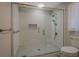 Modern bathroom featuring a glass-enclosed shower with dual shower heads and tiled walls at 825 Sugar Creek Se Way, Conyers, GA 30094