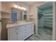 Elegant bathroom with a double sink vanity, marble countertop, and a walk-in closet at 825 Sugar Creek Se Way, Conyers, GA 30094