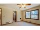 Bright bedroom featuring a ceiling fan, double window and neutral carpet at 825 Sugar Creek Se Way, Conyers, GA 30094