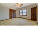 Bedroom featuring wood trim, a large window with natural light, and a spacious closet for storage at 825 Sugar Creek Se Way, Conyers, GA 30094