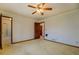 Bedroom featuring carpeted floors, wood trim, and an en-suite bathroom, offering comfort and convenience at 825 Sugar Creek Se Way, Conyers, GA 30094