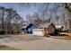 Blue home with garage door, stone details, mature trees, and a well-maintained driveway at 825 Sugar Creek Se Way, Conyers, GA 30094