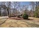 Expansive front yard showcasing manicured landscaping and mature trees surrounding the beautiful home at 825 Sugar Creek Se Way, Conyers, GA 30094