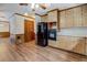 Classic kitchen design featuring wooden cabinets, black appliances, and hardwood flooring at 825 Sugar Creek Se Way, Conyers, GA 30094